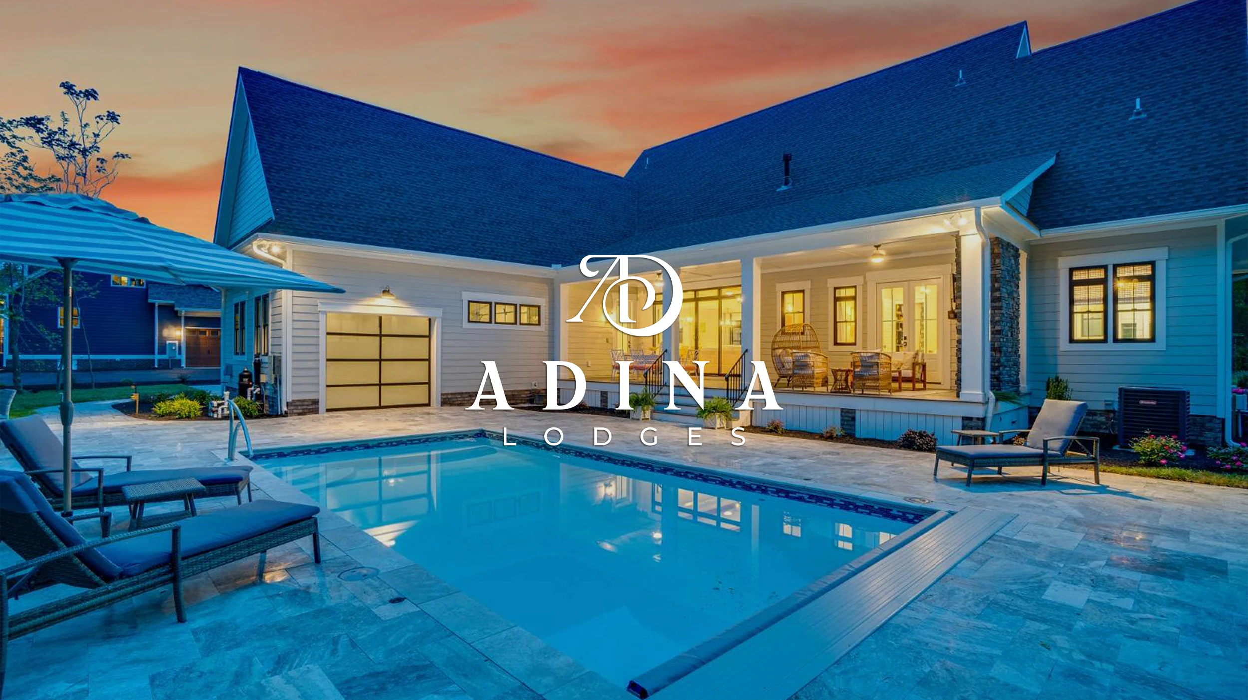ADINA Lodges logo in white over a lodge and lit swimming pool at dusk